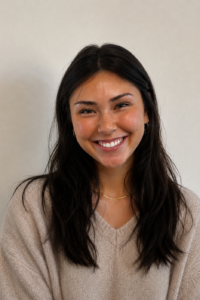 Woman in tan sweater.